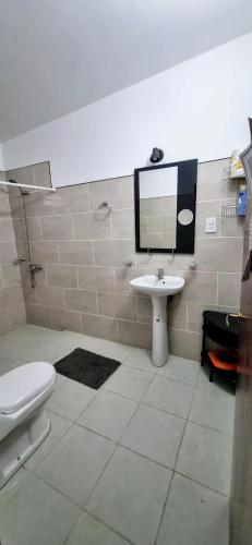 a bathroom with a sink and a toilet and a mirror at Casa-Rancho Grande in Santa María