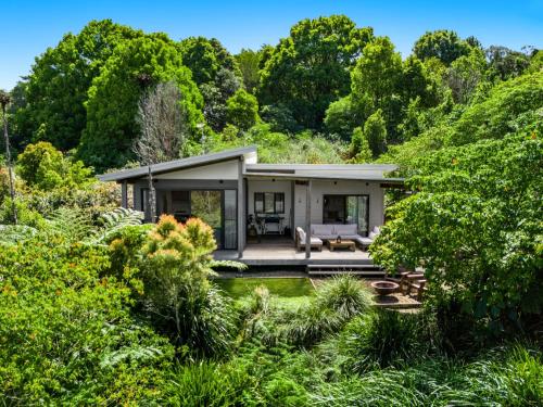 a house in the middle of a garden at Pacificserenity in Coopers Shoot