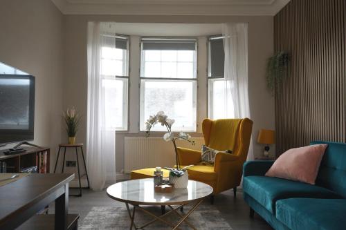 a living room with a couch and a table at Falkirk City Centre Stylish Two-Bedrooms Apartment in Falkirk