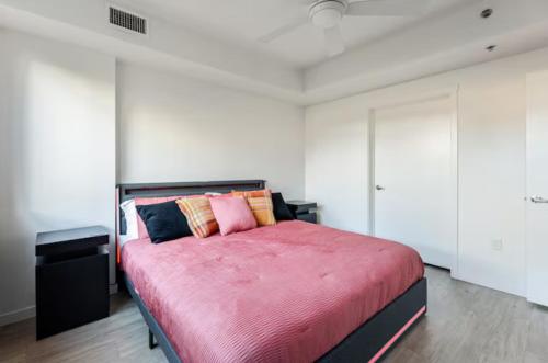 a bedroom with a large bed with a red blanket at Modern Mile High in Sloans Lake in Denver