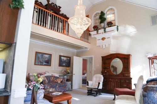 a living room with a staircase and a couch at Copeland Castle in Greensboro