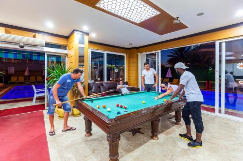 a group of people standing around a pool table at Galaxy Beach Hotel Alanya in Mahmutlar