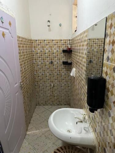 a bathroom with a white sink and a shower at Rent Mombassa Mtwapa Kenya 2people in Bardejov