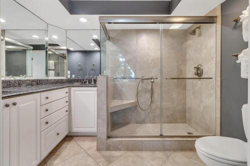 a bathroom with a shower and a toilet at SW122D: 122D Shipwatch in Isle of Palms