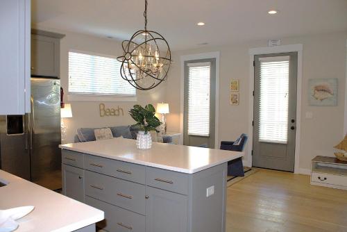 a kitchen with a island in the middle of a room at 410B The King Neptune House in Virginia Beach