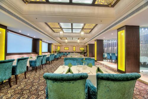 a dining room with tables and chairs and a large window at Best Western Summerlea in Jalandhar