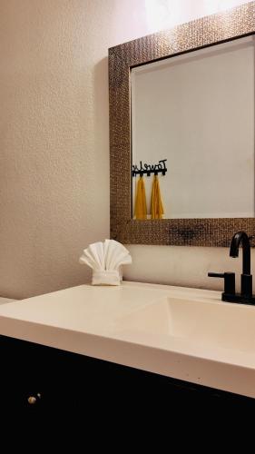 a bathroom with a sink and a mirror at 12 min to Phoenix Raceway Perfect for Large groups &Work in Cashion