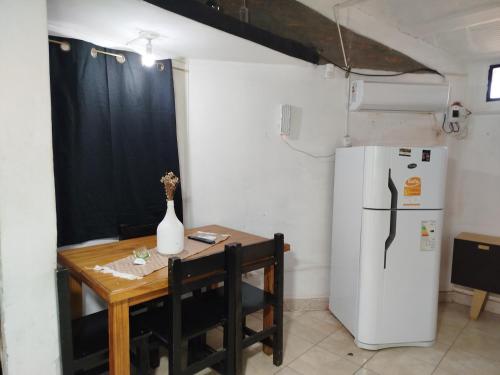 a small kitchen with a table and a refrigerator at Bruna Zona Alta in San Fernando del Valle de Catamarca