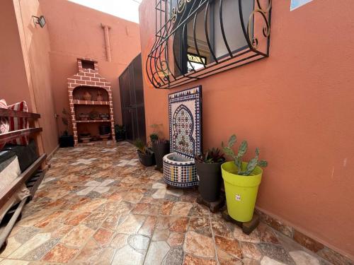a hallway with potted plants and a staircase in a building at Casa del sol Sidi Ifni in Sidi Ifni