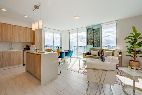 a kitchen and living room with a table and chairs at 3900-902CH DESIGN DISTRICT, CONDO 2 BEDROOMS & 2 BATHROOMS in Miami