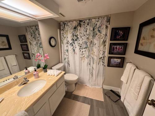 a bathroom with a sink and a toilet and a shower at Charming & Cozy 2-Bedroom in the Heart of Cathedral City! in Cathedral City