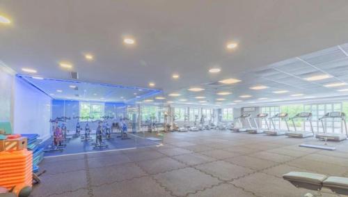 a gym with a large room with rows of exercise equipment at Chateau Libertador Sophisticated 4 bedroom high floor river view large private terrace in Buenos Aires