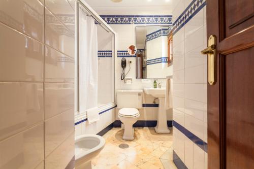 a bathroom with a toilet and a sink at Hotel Baco in Seville