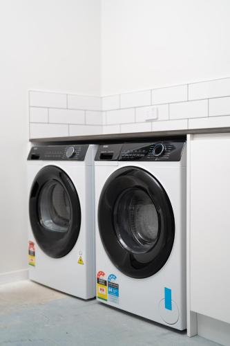 two washing machines sitting next to each other at The Alpine Lakeview Luxe Retreat in Queenstown