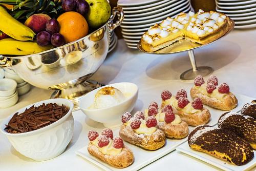 a buffet of pastries and desserts on a table at Impérial Palace in Annecy