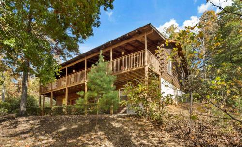 a wooden house in the woods with trees at Cedar Ridge in Mill Spring