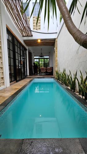 a swimming pool in the middle of a house at Vila Raima SYARIAH in Gresik