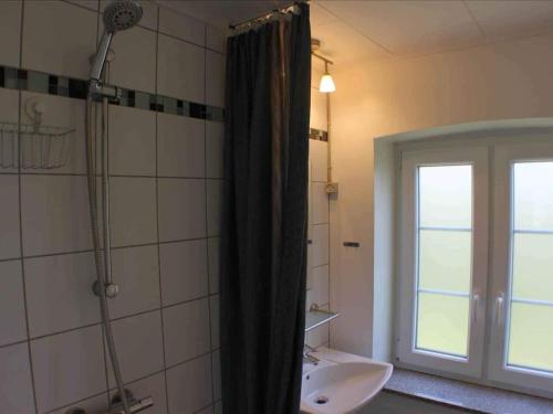 a bathroom with a shower and a sink and a window at 5 star holiday home in Søby Ærø in Soby Mark