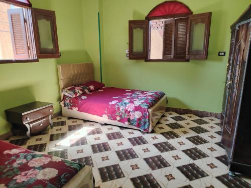 a bedroom with a bed and a tiled floor at Venti house in Aswan