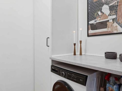 a laundry room with a washer and dryer at 5 star holiday home in Søby Ærø in Søby