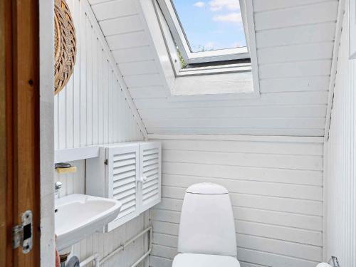 a bathroom with a toilet and a sink and a skylight at 5 star holiday home in Hundested in Kulhuse