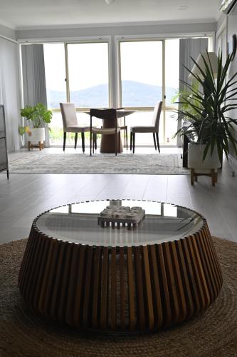 a living room with a coffee table and a living room with a table at Riverside Retreat in Karuah