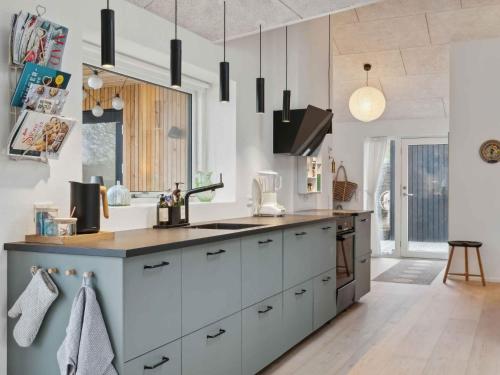 a kitchen with white cabinets and a counter at 5 star holiday home in Odder in Norsminde