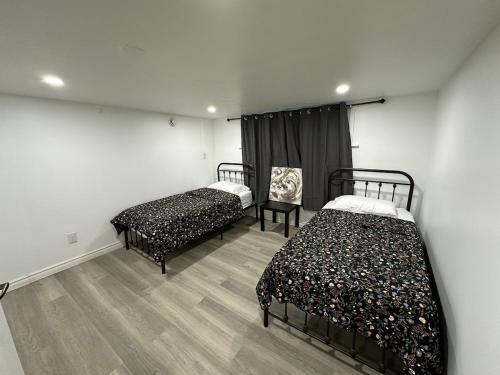 a room with two beds in a room at Modern 2 Bedroom Suite, Excellent Location Near Downtown & Airport in Kitchener