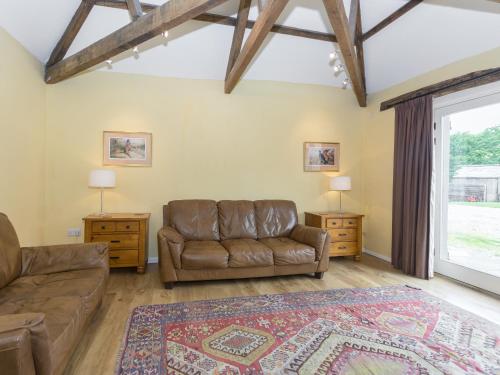 a living room with a couch and a table at Ingleby Barn - 27946 in Battersby