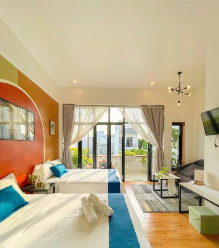 a large bedroom with two beds and a television at Terralia Villa in Lagi