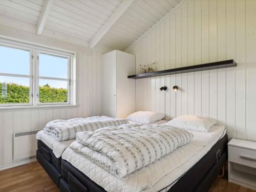 a bedroom with two beds and a window at 5 star holiday home in Haderslev in Råde