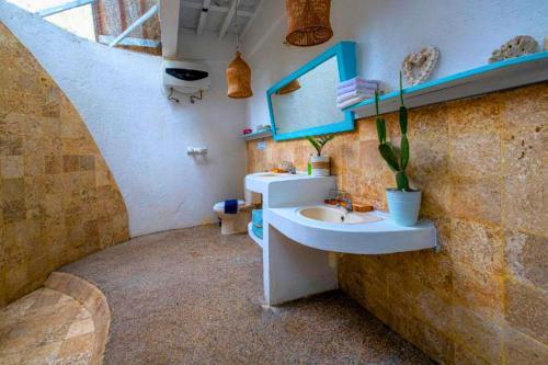 a bathroom with a sink and a staircase at Cleosa 2 BR Cozy Bungalow Family ZN301 in Gili Air