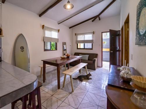 a living room with a table and a couch at The Cafecito Surfhouse - Santa Teresa in Santa Teresa Beach