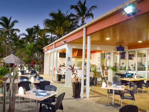 a restaurant with tables and chairs in front of a building at Tangalooma Sands in Tangalooma