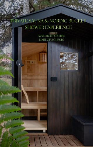 a wooden sauna with a sign on the door at The Quarters in Strahan