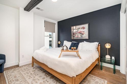 a bedroom with a large bed with a table on it at The Saddlery - The Vault - 2 Min Walk to Broadway in Nashville