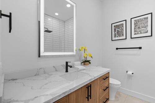 a white bathroom with a sink and a toilet at Scottsdale - 1501 N Miller Rd #1015 in Scottsdale
