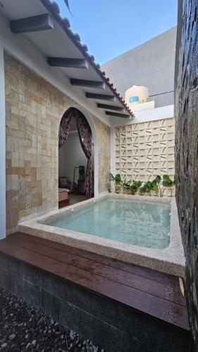 a swimming pool in the middle of a building at Pondok Raima SYARIAH with Mini Pool in Giri