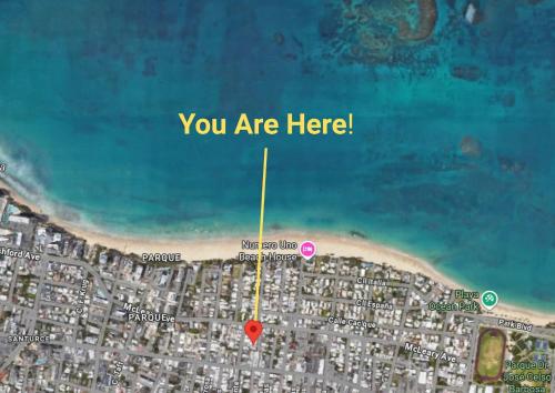 Un mapa de una playa con un círculo rojo y un punto rosa. en Ocean Park Studio Steps to beach Keyless entry, en San Juan