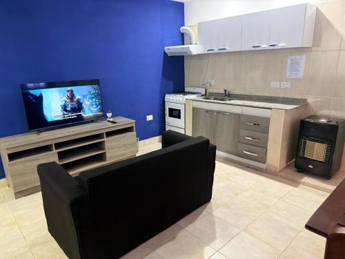 a kitchen with a couch and a tv on a counter at Casa Azul in La Quiaca