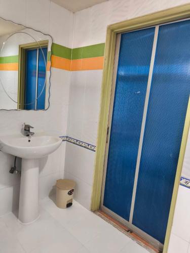 a bathroom with a sink and a glass shower door at Silver Reef in Udon Thani