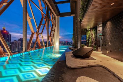 a swimming pool on top of a building with a city skyline at Scarletz Residence Near By KLCC in Kuala Lumpur