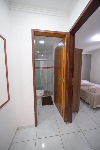 a bathroom with a shower and a toilet in a room at Casa Queiroz in Maracaipe