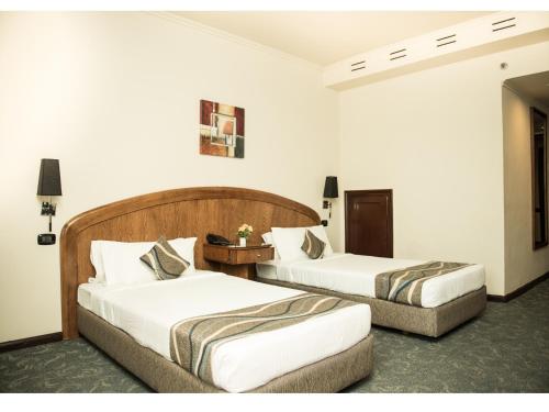 Katil atau katil-katil dalam bilik di Cherry Maryski Hotel