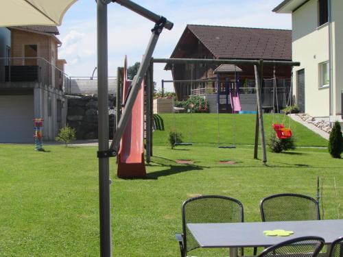 a playground with a table and chairs in a yard at Hotel Landgasthaus Neues Bild, Eggerstanden in Appenzell