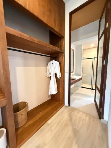 a hallway with a door with a robe hanging on it at Likita Resort in Ban Phe