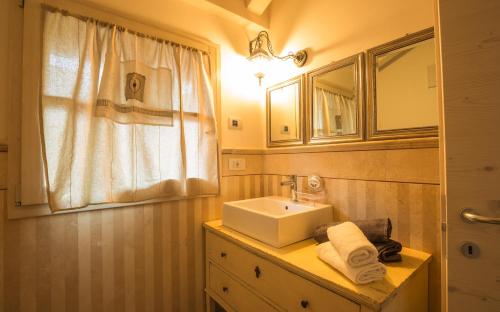 a bathroom with a sink and a mirror at Ledro Mountain Chalet in Ledro