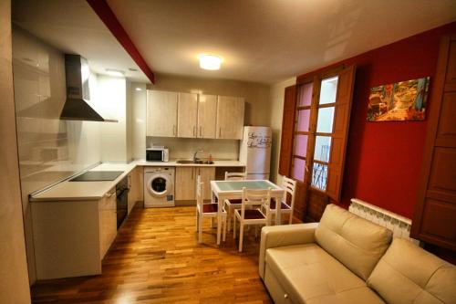 a kitchen with a couch and a table in a room at El Mirador del Rioja, Zona Laurel in Logroño