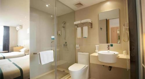a bathroom with a toilet and a sink and a shower at City Comfort Inn Yichang Dongshan Three Gorges University Shuiyuecheng in Yichang