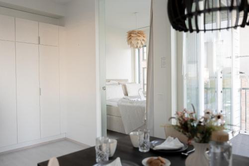 a dining room with a table and a mirror at Hostit Arctic Apartments By BookLapland in Rovaniemi